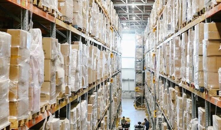 Towering stacks of protected packages, stretching into the vastness of the warehouse